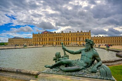 Versailles, France - April 24, 2019: The statues and fountains in and around the garden of Versailles Palace on a sunny day outside of Paris, France.