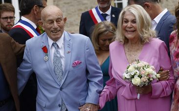 US WWII veteran Harold Terens, 100, left, and Jeanne Swerlin, 96, arrive to celebrate their wedding at the town hall of Carentan-les-Marais, in Normandy, northwestern France