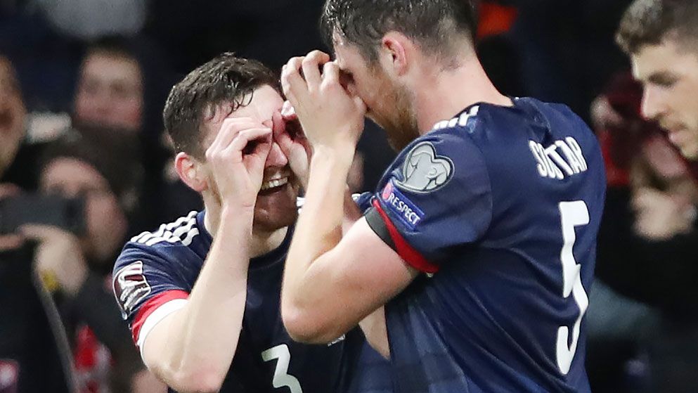 John Souttar of Scotland celebrates with Andy Robertson after scoring the opening goal during the 2022 FIFA World Cup Qualifier against Denmark. 