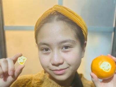 mother and daughter smiling orange 