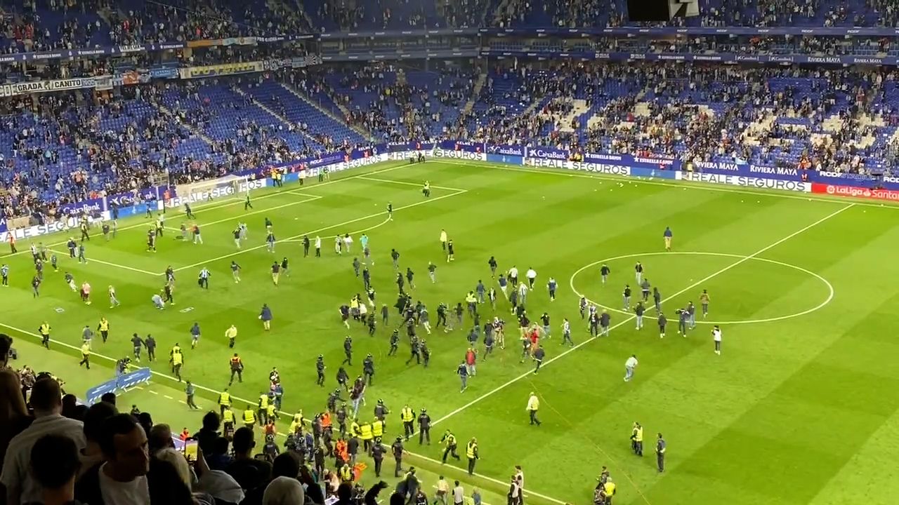 Barcelona players flee scary pitch invasion after clinching Spanish league title