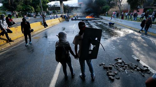 Protesters have maintained months of riots against the Maduro regime. (AAP)