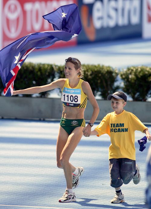 Kerryn McCann celebrates with her son Brenton, 9, after winning gold in the Women's Marathon at the Melbourne Cricket Ground at the Commonwealth Games in 2006. Picture: AAP