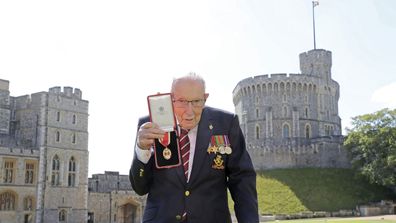 Captain Sir Thomas Moore poses after being awarded with the insignia of Knight Bachelor by Queen Elizabeth II at Windsor Castle on July 17, 2020 in Windsor, England.