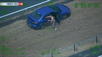 The man fires at police after the car he was driving hits road spikes. (9NEWS)