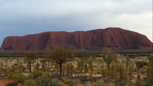 Three men rescued from Uluru after being asked not to climb