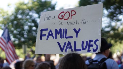 Protesters hold signs during a "Families Belong Together" rally in Washington, DC on June 14. Picture: CrowdSpark