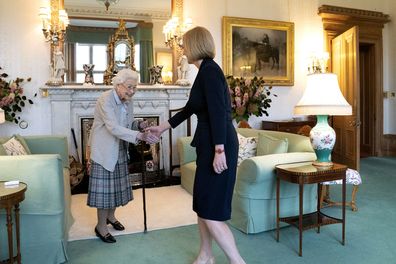 Queen Elizabeth II, left, welcomes Liz Truss during an audience at Balmoral, Scotland, where she invited the newly elected leader of the Conservative party to become Prime Minister and form a new government, Tuesday, September 6, 2022.