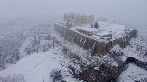 In Athens, rare snow blankets the Acropolis, halts coronavirus vaccinations