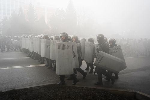 Riot police walk to block demonstrators during a protest in Almaty, Kazakhstan, Wednesday, Jan. 5, 2022. 