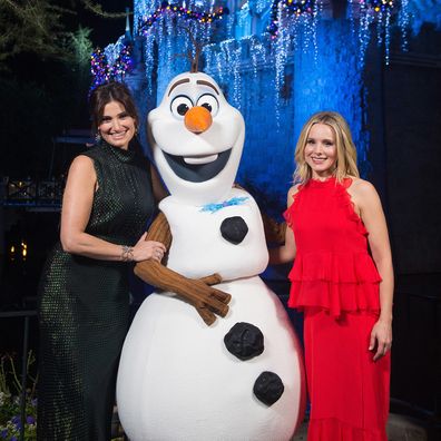 Idina Menzel and Kristen Bell of Frozen pose with Olaf before a taping of "The Wonderful World of Disney: Magical Holiday Celebration" at Walt Disneyland on November 14, 2017 in Anaheim, California.