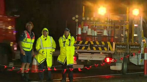 The car struck the man when it crashed through overnight roadworks. (9NEWS)