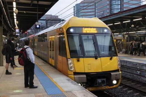 Early morning commuters at Central Station. Metro trains are back running at reduced capacity today, with services on most lines departing every 30 minutes. 22 February, 2022. Photo: Brook Mitchell