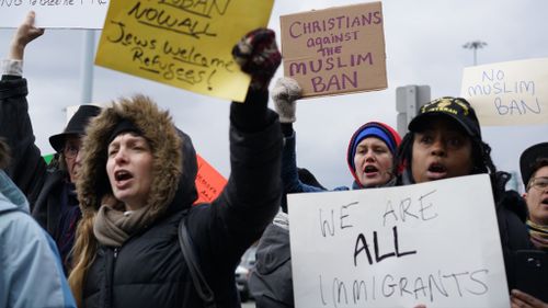 Protesters gather outside New York's JFK airport. (AAP)