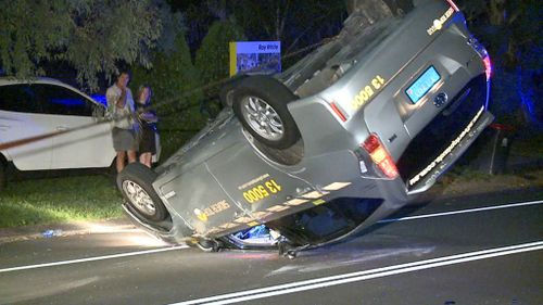 Taxi driver crashes into two parked cars and flips cab in Sydney's north-west