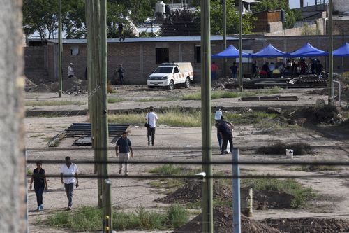 Police work in the lot next to the home of Gilad Pereg where the bodies of his mother and aunt were found in Mendoza, Argentina, on Saturday.