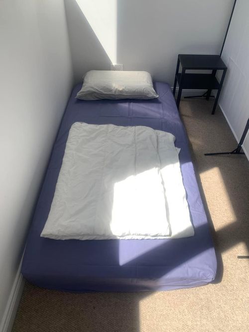 The two floor mattresses are separated by a partition. 