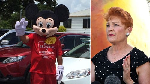 A Mickey Mouse costumed Labor supporter attempted to heckle Senator Hanson earlier on Friday in Ayr during her 'Battler Bus' tour (Image: Darren Curtis and AAP)