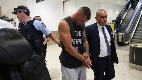 Stephen Martin being arrested upon arrival at Sydney Airport this morning. (Image: AAP)