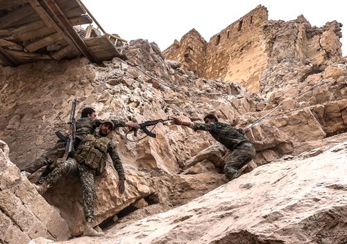 March 2016. Syrian government army soldiers on their way to the top of Fakhr al-Din al-Maani Citadel, a UNESCO world heritage site, to put a flag. (Photo by Valery Sharifulin\TASS via Getty Images)