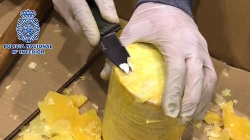 The searches uncovered wax-covered cylinders hidden inside pineapples. (Policia Nacional M Interior)