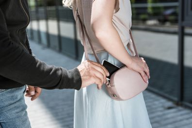 Man stealing smartphone from woman's.