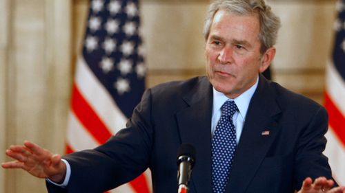 The then-president George W. Bush, reacts, after shoes were thrown at him, by a correspondent, during a joint press conference with Iraq Prime Minister Nouri al-Maliki, not seen, in Baghdad, Iraq, Dec. 14, 2008.