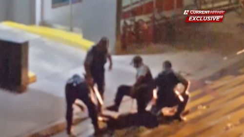 One of the police officers is seen hitting the boy more than a dozen times with a police baton.