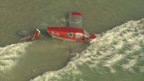A light aircraft ditched into the ocean off Perth's City Beach with a pilot and passenger on board escaping