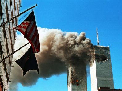 Dark, toxic smoke pours from the twin towers of the World Trade Center on September 11, after two hijacked planes hit each structure, later causing each to crash to the ground.