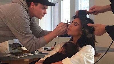 Kim Kardashian with snuggles with North West while being styled for an event in 2015.
