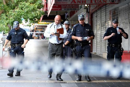 Officers were seen scouring the Bankstown area for clues on the shooter. (AAP)