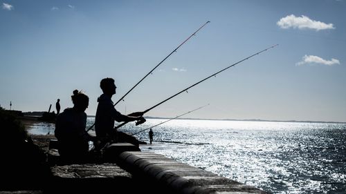 People fishing in the seaside town of Dromana.