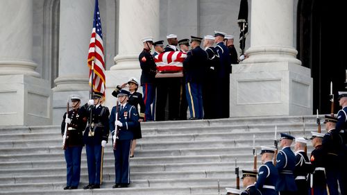 The casket of George HW Bush is taken from the Capitol Rotunda.