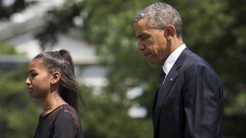 Barack Obama arrives at the service with daughter Sasha. (AAP)