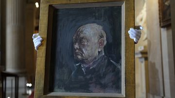 A member of staff from Sotheby&#x27;s poses for the media with a portrait of the iconic former British Prime Minister Winston Churchill, painted by Graham Sutherland in 1954, at Blenheim Palace, Woodstock, England, Tuesday, April 16, 2024.