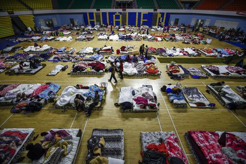 People displaced by the earthquake camp out at a gymnasium in Hualein. (AAP)