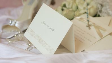 "Wedding invitation with following items in the background: bride's bouquet, cross, garter, jewelery and shoe.You need more wedding and dinner related imagesPlease, follow the link below:"