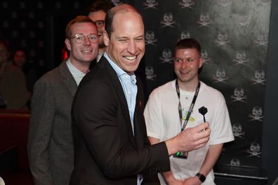 Prince William, Prince of Wales takes part in a game of interactive darts in the 180 Club during a visit to The Rectory during their visit to Birmingham on April 20, 2023 