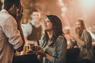 Woman proposes to man. Couple get engaged. Proposal. Couple's engagement. 