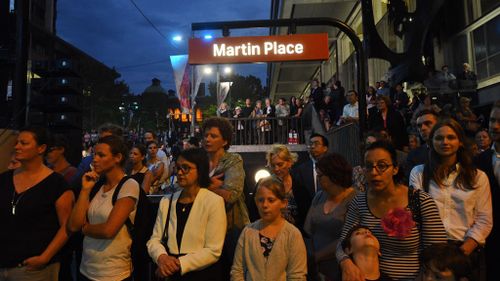 Members of the public gather at a ceremony to commemorate the first anniversary of the Lindt Café siege at Martin Place in Sydney. (AAP)