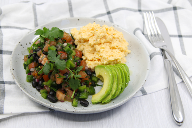 Healthy Mexican scrambled eggs with avocado and salsa