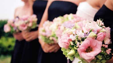 Bridesmaids with flowers - foreground only in focus. Beautiful Springtime bouquets in pink and green.