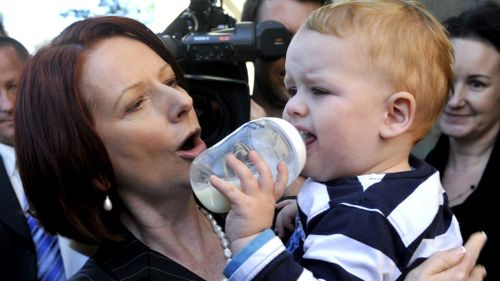 Prime Minister Julia Gillard holds a baby at the Casula Powerhouse Museum in Sydney, during the 2010 campaign. (AAP)