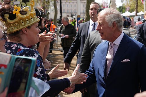 King Charles III greets members of the public along the Mall as preparations continue for The Coronation on May 5, 2023 in London
