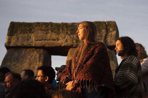 Revellers participate in the summer solstice gathering at Stonehenge, Salisbury (EPA/WILL OLIVER).