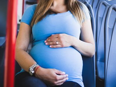 Pregnant woman sitting on bus