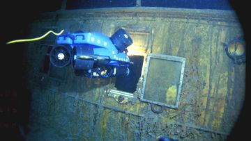 An underwater remote vehicle examines an open window of the Titanic 3.8 kilometres below the surface of the ocean, 640 kilometres off the coast of Newfoundland, Canada in 1986.