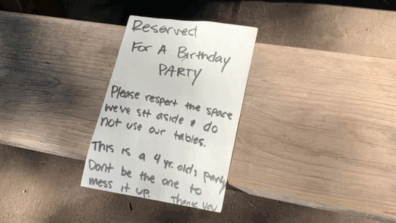 Parents shamed on Reddit for poor park etiquette after leaving note to 'reserve' tables for child's birthday party.  