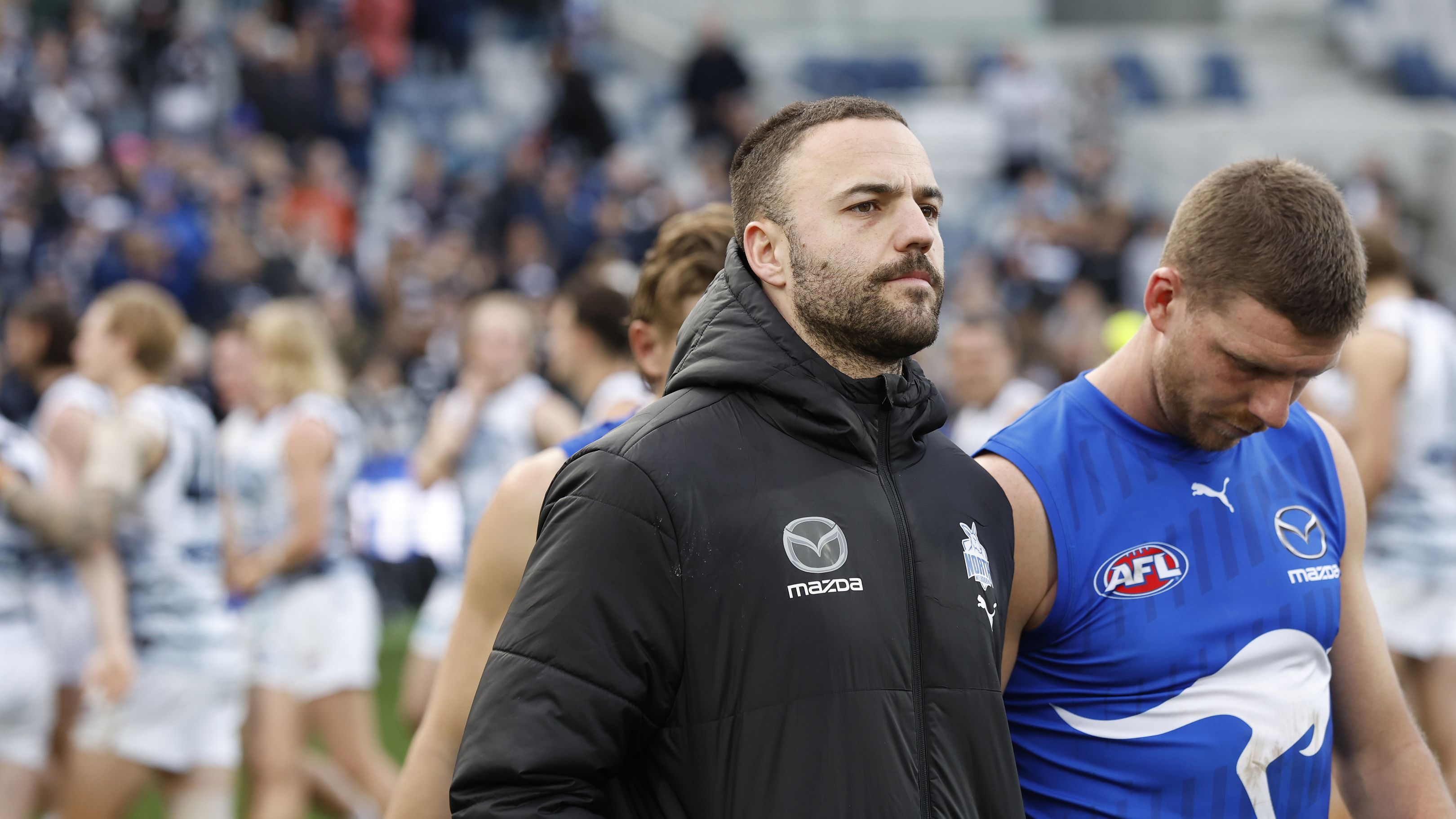 GEELONG, AUSTRALIA - JULY 09: Griffin Logue and Aidan Corr of the Kangaroos walk from the ground after during the round 17 AFL match between Geelong Cats and North Melbourne Kangaroos at GMHBA Stadium, on July 09, 2023, in Geelong, Australia. (Photo by Darrian Traynor/Getty Images)
